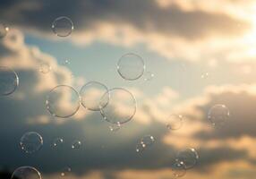 Numerous soap bubbles drift effortlessly against a backdrop of an overcast sky and sunlight. photo
