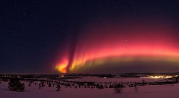 Stunning display of the aurora borealis dancing across the night sky over a snowy terrain. photo