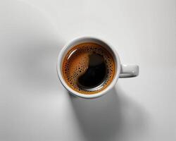 Top View of Freshly Brewed Coffee in a White Mug on Light Surface photo