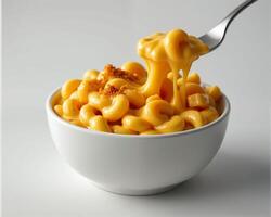 Creamy Macaroni and Cheese in White Bowl with Fork Lifting Pasta photo