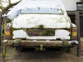 Close Up of Rusty Abandoned Car with Moss photo