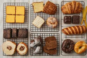 Various types of breads and pastries on a wire rack photo