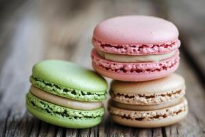 Three macarons are stacked on top of a wooden table photo