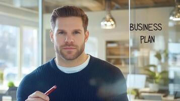 Determined entrepreneur drafting strategic business plan on glass board photo
