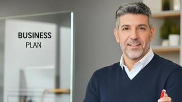 Mature professional presenting a Business Plan strategy in the office space photo