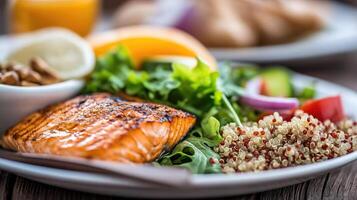 Delightful meal featuring grilled salmon, vibrant salad, and nutritious quinoa photo