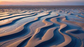 Sand Dune Patterns on Beach at Sunset with Horizon and Reflections photo