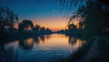 Serene River Flowing Under a Dusk Sky with Trees Silhouetted photo