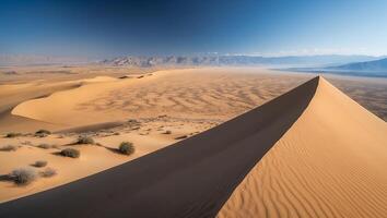 Sand Dune Landscape with Mountains and Blue Sky photo