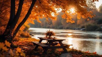 Picnic Table by River in Autumn Landscape photo