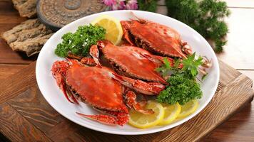 a plate of crabs with lemon slices and parsley photo