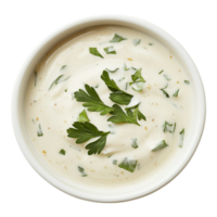 A bowl of white sauce with parsley on top png