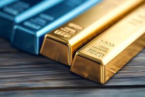 Gold and other precious metal bars resting on wooden table photo