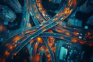 Highway interchange traffic flowing at dusk, aerial view of urban mobility photo
