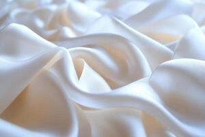 Luxurious white silk or satin texture background forming folds and waves photo