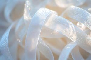White ribbons creating elegant swirling pattern with delicate sparkles photo