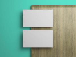 Two business card mockup in vertical alignment on wood tray, clean branding template on teal background. photo