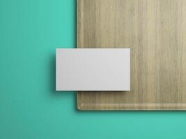 Minimalist business card mockup on wood tray and teal background, perfect for branding presentations. photo