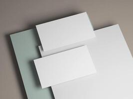 Clean business card mockup with soft gray, white, and pastel green background layers. photo