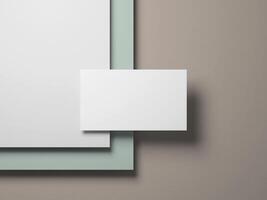 Elegant minimalist business card mockup with clean white card floating over soft green and beige layers. photo