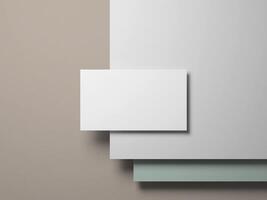 Business card placed on layers of white and soft pastel colors, perfect for showcasing elegant and modern branding. photo