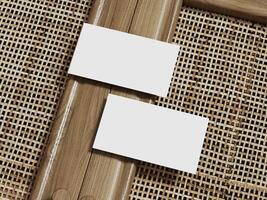 Two blank business cards mockup on a rattan weave background, framed with wood for an elegant and modern presentation. photo
