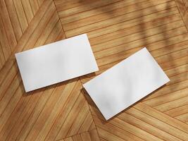 Business card mockup with two cards on a wooden floor, featuring sharp angles and soft shadows for a professional look. photo