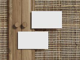 Blank business card mockup displayed on a rattan textured background with a sleek wooden border. photo
