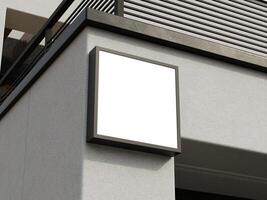 Sophisticated and empty square sign mockup mounted on a building wall, perfect for custom designs. photo