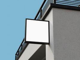 Blank sign mockup with a minimal square design mounted on a building corner for branding purposes. photo