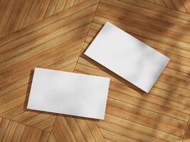 Business card mockup featuring two cards set against wooden background, showcasing a simple yet elegant design. photo