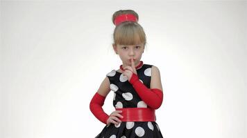 Adorable girl making a shhh gesture against a bright white background video