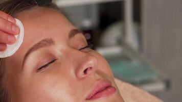 Young woman enjoying a rejuvenating ultrasonic facial treatment at a beauty salon video