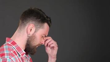Thoughtful bearded man grapples with a challenging problem video