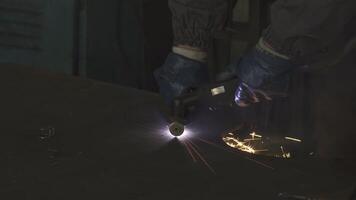 Dynamic factory worker cutting steel with sparks flying in a vibrant display video