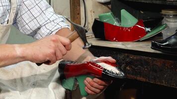 Dedicated shoemaker crafting exquisite shoes in his workshop video