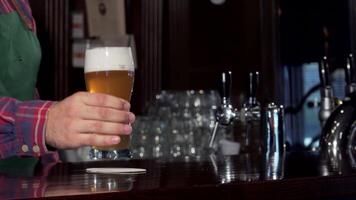 Bartender expertly pouring a refreshing glass of beer at a lively pub video