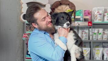 Joyful man embracing his playful dog, beaming at the camera video