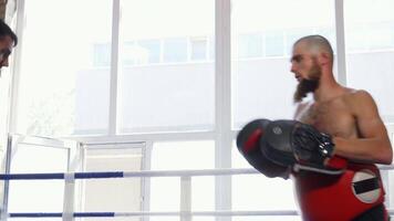 Dynamic sparring session between two male MMA fighters in action video