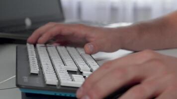 Focused male hands typing swiftly on a sleek computer keyboard video