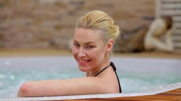 Radiant woman enjoying a blissful soak in a hot tub video