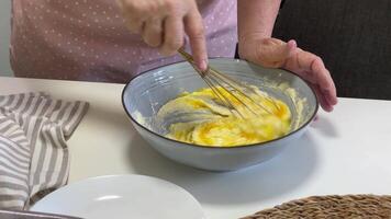 Pastry chef whisking ingredients in bowl for cake video