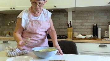 Flour is sifted in to batter in a bowl video
