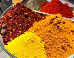 Colorful spices creating a vibrant and aromatic display in a glass bowl photo