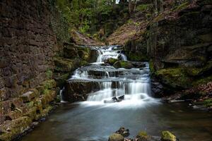 Waterfall cascading down rocks in a peaceful forest setting photo