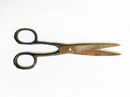 Antique scissors on white background. A weathered, rustic tool suggesting themes of time, craftsmanship, and the passage of years. Perfect for vintage, historical, or DIY projects. photo