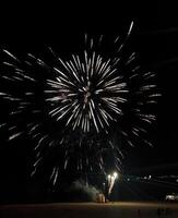 Stunning fireworks display explodes across the night sky, creating a breathtaking spectacle of light and color. Perfect for celebrating holidays, events, or adding a festive touch to your designs. photo