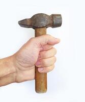 Closeup of a hand firmly gripping a worn, vintage claw hammer. The image evokes themes of craftsmanship, DIY projects, and manual labor. photo
