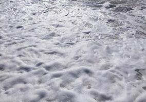 beach midday with gentle waves lapping the shore and clear blue skies inviting relaxation photo