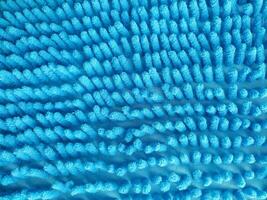 Detailed closeup of a textured, fluffy blue surface. Abstract and inviting, suggesting cleanliness, softness, and comfort. Ideal for backgrounds or design elements. photo